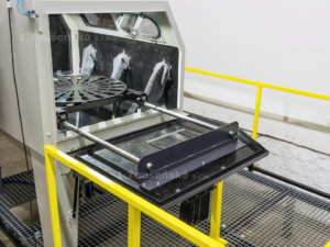 blast cabinet with a turntable inside the workplace